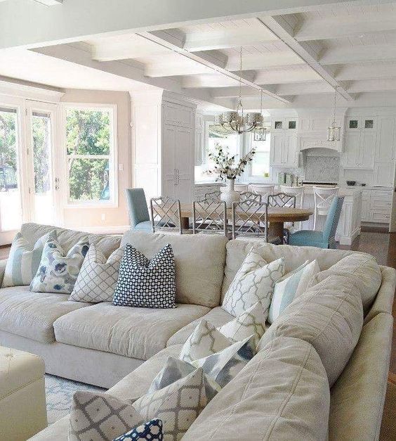 neutral living room open to the kitchen